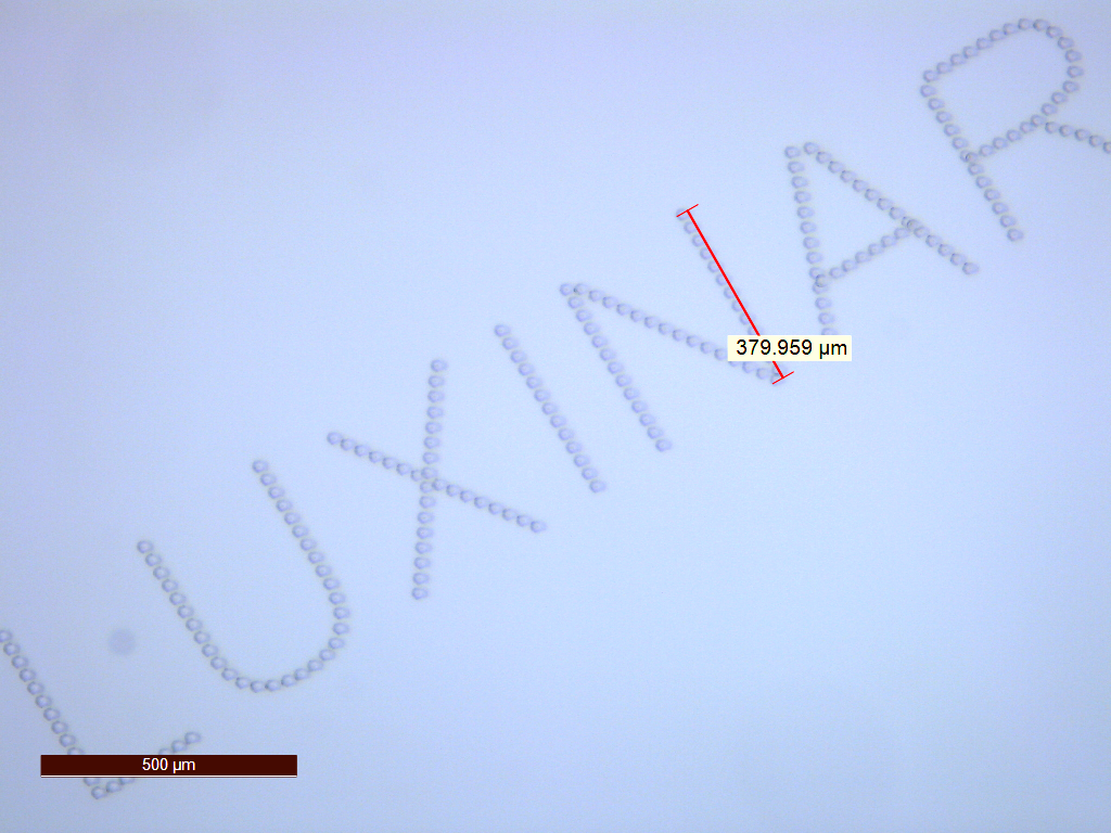 FIGURE 1. Subsurface marking in glass, with characters less than 0.5 mm high, is possible with femtosecond laser sources.
