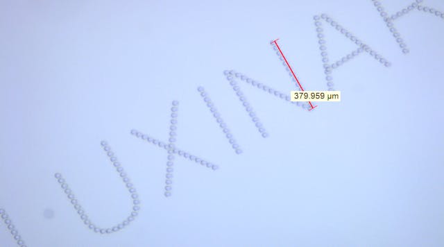 FIGURE 1. Subsurface marking in glass, with characters less than 0.5 mm high, is possible with femtosecond laser sources.
