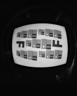 FIGURE 3. An image from a NRI system using a single metaoptical element surface (1M MOE) designed for 940 nm wavelength. The demonstrated image has excellent resolution for edge-to-edge NIR imaging and is comparable to images captured with a multi-element refractive lens. FIGURE 3. An image from a NRI system using a single metaoptical element surface (1M MOE) designed for 940 nm wavelength. The demonstrated image has excellent resolution for edge-to-edge NIR imaging and is comparable to images captured with a multi-element refractive lens.