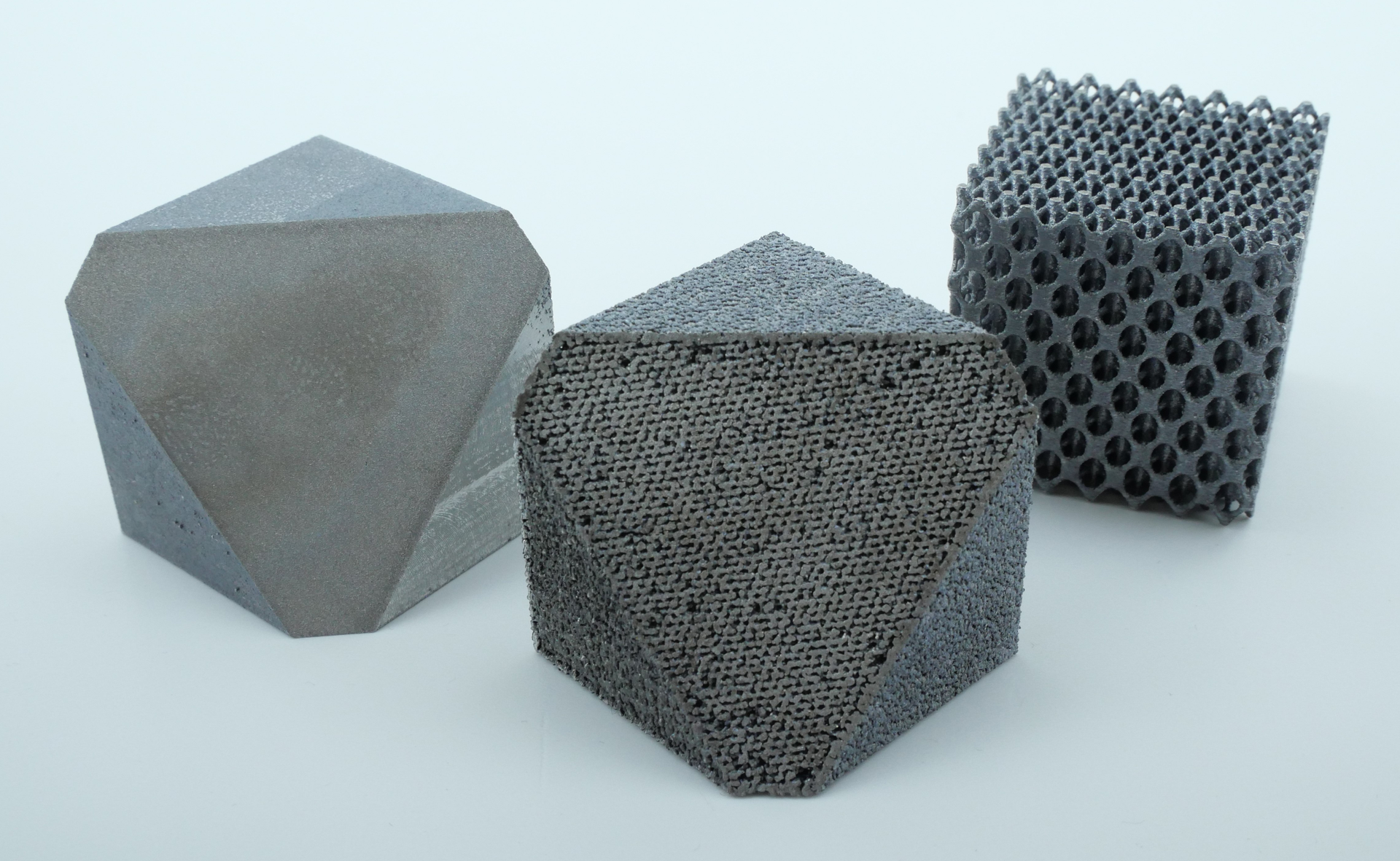FIGURE 1. Examples of a dense manufactured diagonally cut cube (left), process-related grid structure (middle), and lattice cube (right).