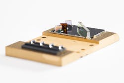 FIGURE 1. Draper’s new packaging and assembly approach enables multiple lenses and beamsplitters to be dropped onto an etched silicon topography, along with pieces of low-melting-temperature solid-glass frit, prefabricated into 3D shapes. FIGURE 1. Draper’s new packaging and assembly approach enables multiple lenses and beamsplitters to be dropped onto an etched silicon topography, along with pieces of low-melting-temperature solid-glass frit, prefabricated into 3D shapes.