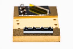 FIGURE 2. V-grooves are located with respect to pyramidal pits to align the optical fiber assembled into v-grooves with respect to the ball lenses assembled into the pits. FIGURE 2. V-grooves are located with respect to pyramidal pits to align the optical fiber assembled into v-grooves with respect to the ball lenses assembled into the pits.