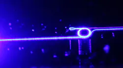 The silicon nitride photonic chip-based microresonator with the butt-coupled, 461 nm EXALOS laser diode.