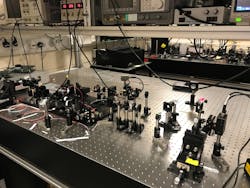 FIGURE 2. This image shows the erbium-fiber-based dual-comb system and experimental setup Wright used to demonstrate her technique. FIGURE 2. This image shows the erbium-fiber-based dual-comb system and experimental setup Wright used to demonstrate her technique.