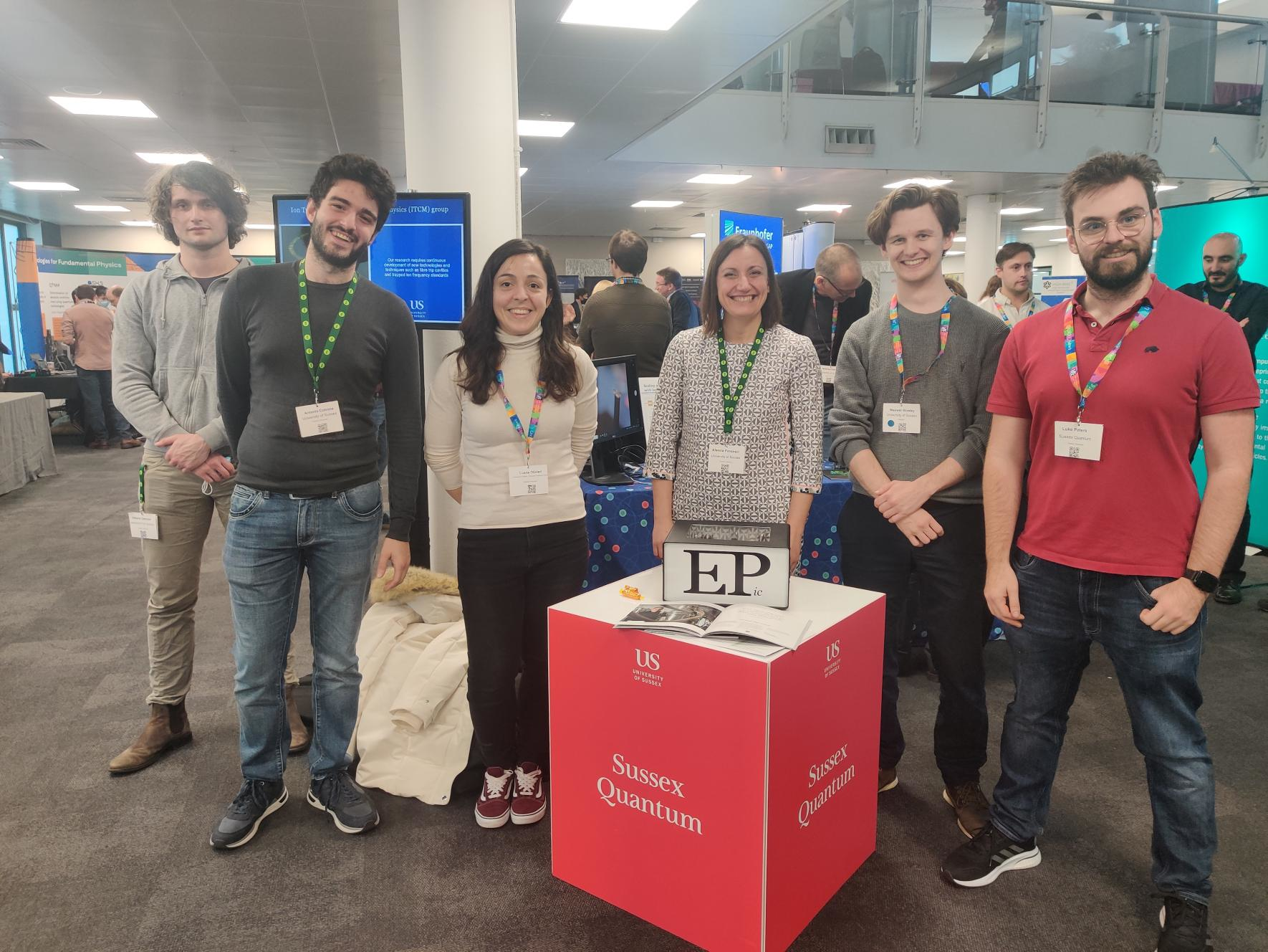 The Emergent Photonics group presenting the microcomb during the quantum showcase, from left to right: Vittorio Cecconi, Antonio Cutronia, Luana Olivieri, Alessia Pasquazi, Maxwell Rowley, and Luke Peters.