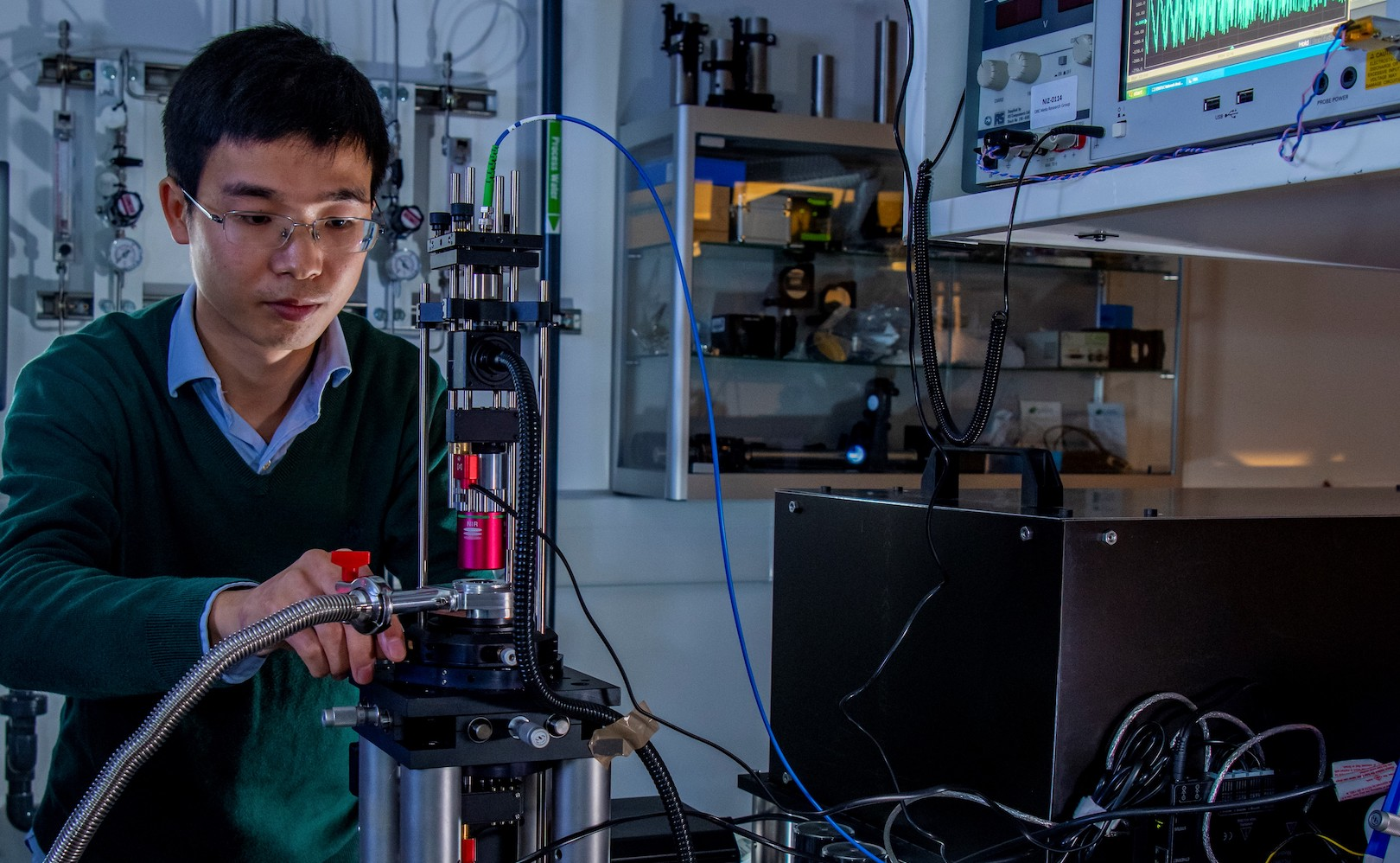 Doctoral research student Jindiang Li working on experimental measurements of optomechanical transmission symmetry.
