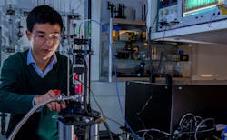 Doctoral research student Jindiang Li working on experimental measurements of optomechanical transmission symmetry. Doctoral research student Jindiang Li working on experimental measurements of optomechanical transmission symmetry.
