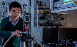 Doctoral research student Jindiang Li working on experimental measurements of optomechanical transmission symmetry.