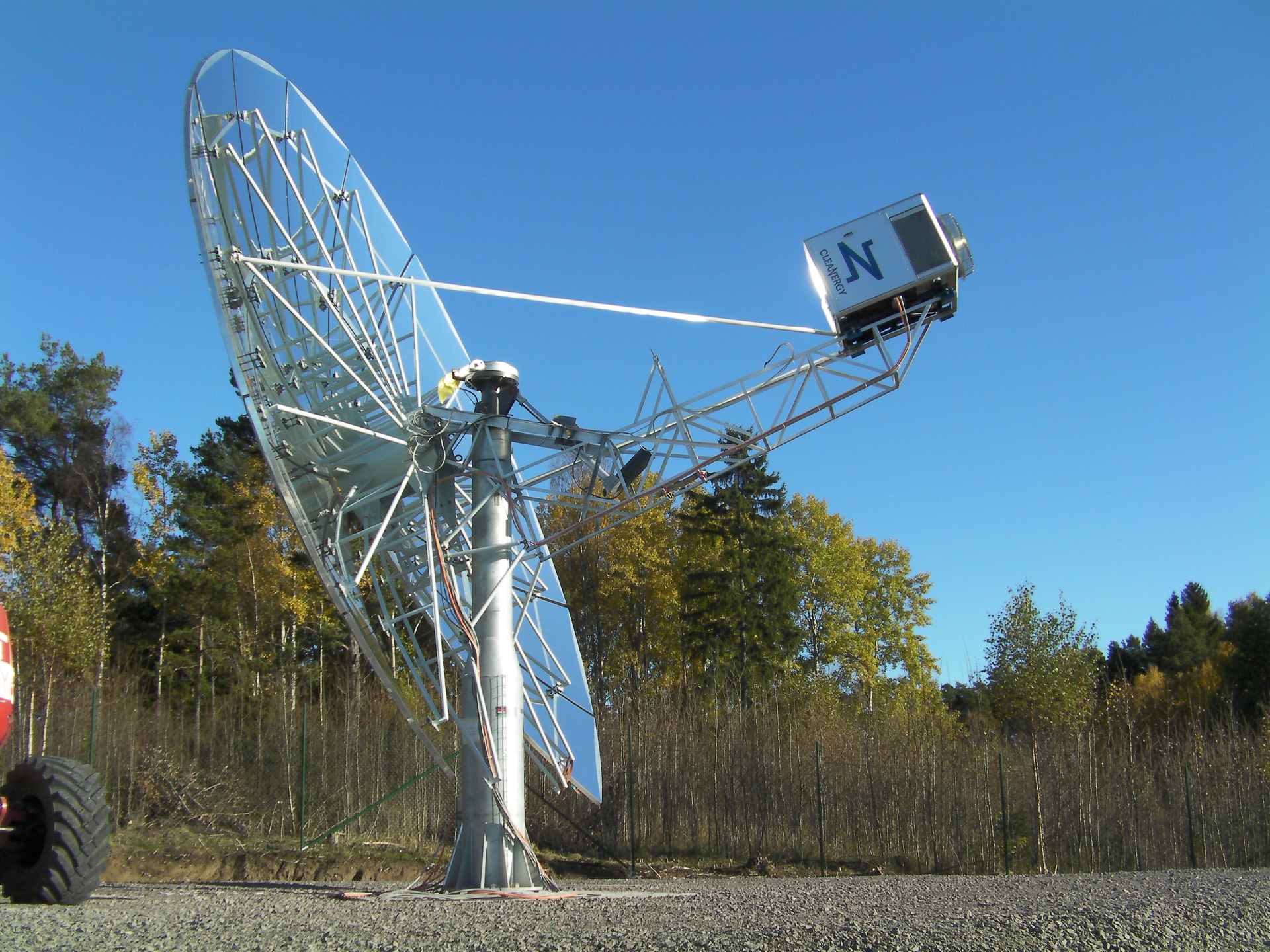 FIGURE 1. The Cleanergy (G&ouml;teborg, Sweden) dish system has a capacity of 11 kW electric power and may be used in standalone or other decentralized applications, as well as clusters with a capacity of up to several hundred megawatts. The parabolic concentrator reflects the incoming solar radiation onto a cavity receiver, which is located at the concentrator's focal point.