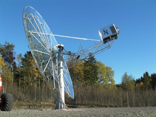 FIGURE 1. The Cleanergy (G&ouml;teborg, Sweden) dish system has a capacity of 11 kW electric power and may be used in standalone or other decentralized applications, as well as clusters with a capacity of up to several hundred megawatts. The parabolic concentrator reflects the incoming solar radiation onto a cavity receiver, which is located at the concentrator&apos;s focal point.