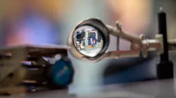 FIGURE 1. A lens on SupreMEtric’s nondestructive spectroscopy-based system produces an inverted image of researchers.
