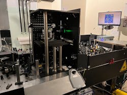 FIGURE 2. Homemade vertical microscope operating in an upright transmission configuration. The investigated sample is raster-scanned through a xyz-translational stage synchronized with the detection scheme constituted by a CCD sensor for the acquisition of single-pixel spectra. Two 0.85 NA objectives are used for sample illumination and for signal collection, respectively. A pseudo-Kohler white-field illumination through an infrared LED allows the researchers to visualize the sample to be imaged with the CARS technique. FIGURE 2. Homemade vertical microscope operating in an upright transmission configuration. The investigated sample is raster-scanned through a xyz-translational stage synchronized with the detection scheme constituted by a CCD sensor for the acquisition of single-pixel spectra. Two 0.85 NA objectives are used for sample illumination and for signal collection, respectively. A pseudo-Kohler white-field illumination through an infrared LED allows the researchers to visualize the sample to be imaged with the CARS technique.