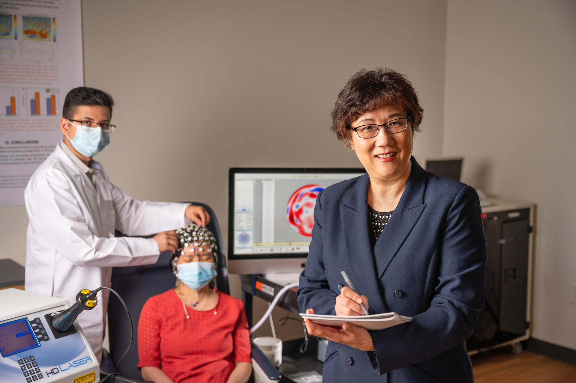 A team led by researcher Dr. Hanli Liu (right) is currently developing a dual-mode brain sensing device that pairs near-IR spectroscopy with EEG for quicker, more accurate detection of Alzheimer&rsquo;s disease.