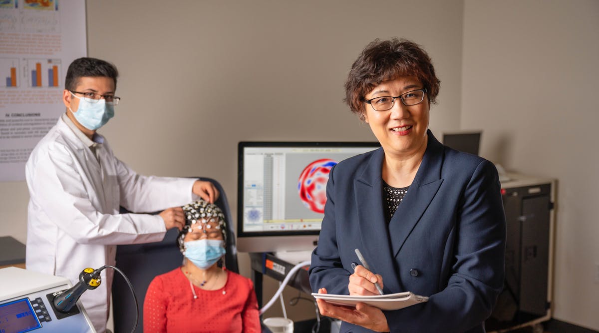 A team led by researcher Dr. Hanli Liu (right) is currently developing a dual-mode brain sensing device that pairs near-IR spectroscopy with EEG for quicker, more accurate detection of Alzheimer&rsquo;s disease.