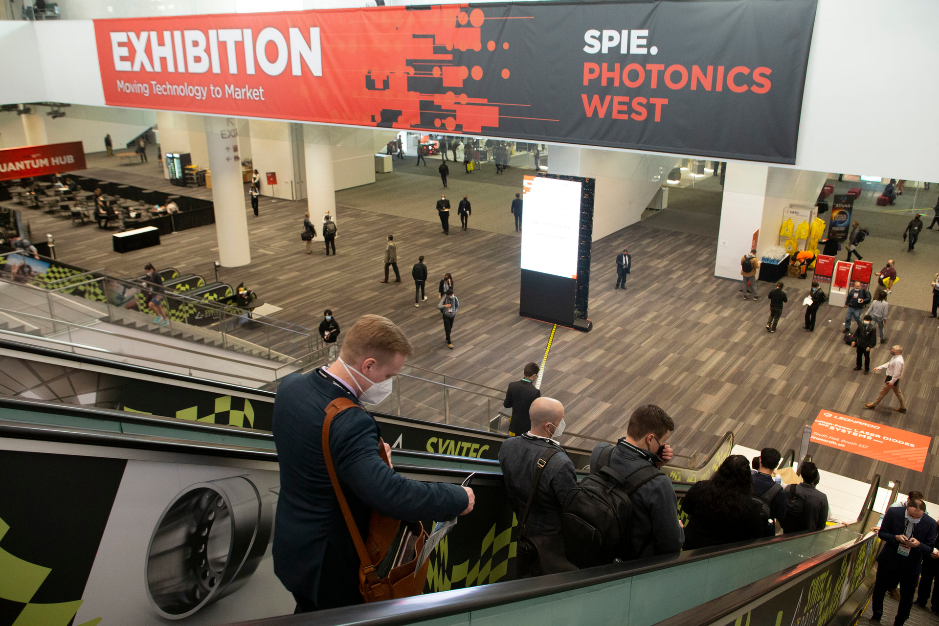 Attendees make their way into the SPIE Photonics West 2022 exhibition hall.