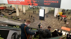 Attendees make their way into the SPIE Photonics West 2022 exhibition hall.