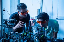 FIGURE 1. Kamyar Parto (left) works in the Moody Quantum Photonics Lab with Arjun Choudhri, a high school student he mentored last summer.