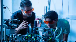 FIGURE 1. Kamyar Parto (left) works in the Moody Quantum Photonics Lab with Arjun Choudhri, a high school student he mentored last summer.