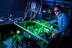 Stefan Witte aligns a laser system used for high-harmonic generation.