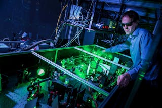 Stefan Witte aligns a laser system used for high-harmonic generation.