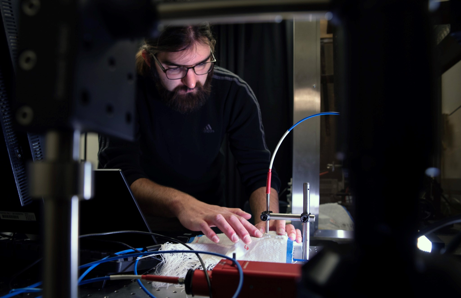 FIGURE 1. Brian Iezzi scans and measures the photonic fibers in the fabric he developed.