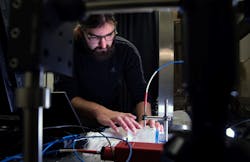 FIGURE 1. Brian Iezzi scans and measures the photonic fibers in the fabric he developed.