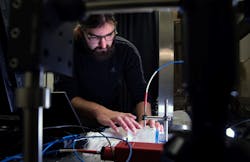 FIGURE 1. Brian Iezzi scans and measures the photonic fibers in the fabric he developed. FIGURE 1. Brian Iezzi scans and measures the photonic fibers in the fabric he developed.