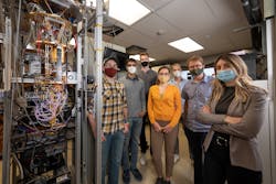 FIGURE 2. Members of the PEACOQ team—(from left) Alex Walter, Sahil Patel, Andrew Mueller, Ioana Craiciu, Boris Korzh, Matt Shaw, and Jamie Luskin—stand next to a JPL cryostat used to test their detector at temperatures as low as -272°C (-458°F). At this temperature, the detector is in a superconducting state, which allows its nanowires to turn absorbed photons into electrical pulses. FIGURE 2. Members of the PEACOQ team—(from left) Alex Walter, Sahil Patel, Andrew Mueller, Ioana Craiciu, Boris Korzh, Matt Shaw, and Jamie Luskin—stand next to a JPL cryostat used to test their detector at temperatures as low as -272°C (-458°F). At this temperature, the detector is in a superconducting state, which allows its nanowires to turn absorbed photons into electrical pulses.