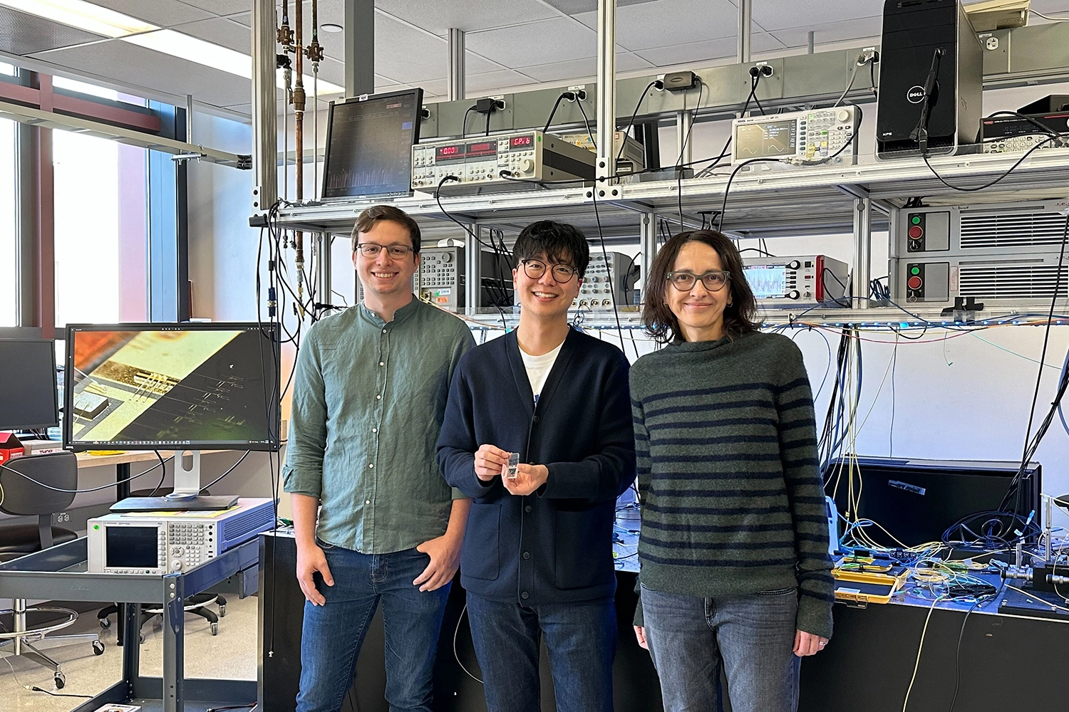 FIGURE 1. Co first-authors Anthony White (left) and Geun Ho Ahn (center) joined their graduate advisor, Jelena Vu&ccaron;kovi&cacute;, professor of electrical engineering at Stanford's Ginzton Laboratory, in developing an integrated passive nonlinear optical isolator based on ring resonators.