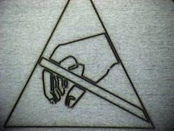 FIGURE 2. A fiber laser is used to provide permanent product warning labels, such as ESD caution labels. FIGURE 2. A fiber laser is used to provide permanent product warning labels, such as ESD caution labels.