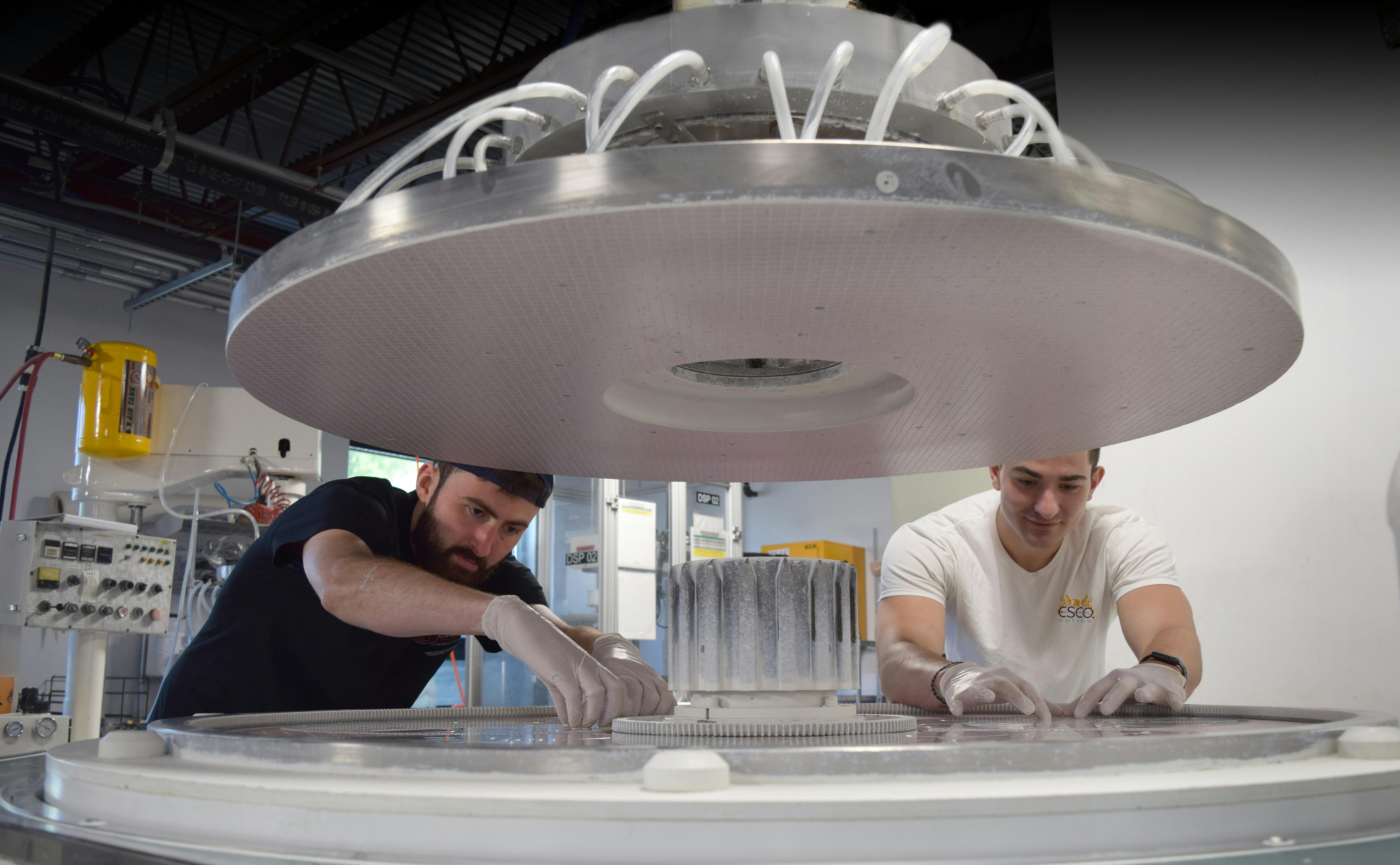 Ryan Hegarty (left) and Stephen Long (right) inspect a run of windows on a double-sided polisher.