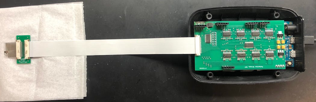 FIGURE 2. A test setup of the prototype sensor. The sensor (left) is connected to a small circuit board (right). A long strip connects to the circuit board incased in plastic.