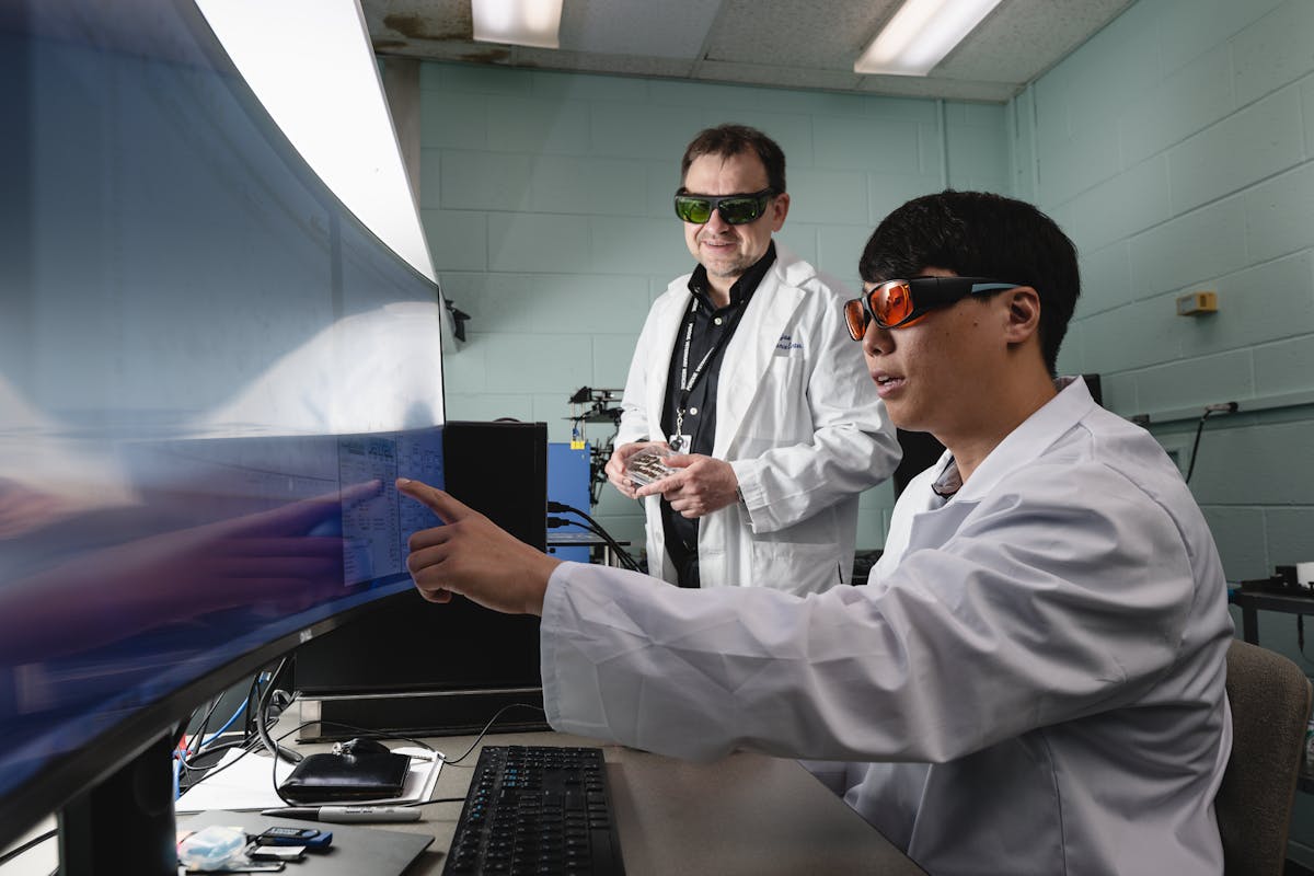 FIGURE 1. Purdue researcher Bartek Rajwa (left) and Purdue postdoctoral fellow Sungho Shin review data produced with a portable LIBS spectroscopy device.