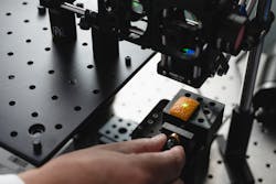 FIGURE 2. LIBS spectroscopy is used by Purdue University researchers to collect data from the surface of an orange. FIGURE 2. LIBS spectroscopy is used by Purdue University researchers to collect data from the surface of an orange.