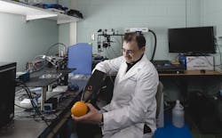 FIGURE 3. Purdue researcher Bartek Rajwa demonstrates how a portable LIBS spectroscopy device is used to collect data from a food surface. FIGURE 3. Purdue researcher Bartek Rajwa demonstrates how a portable LIBS spectroscopy device is used to collect data from a food surface.