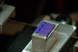 A passive chip from one of the AIM Photonics PIC Kits being optically characterized at Bridgewater State University in Massachusetts. A passive chip from one of the AIM Photonics PIC Kits being optically characterized at Bridgewater State University in Massachusetts.