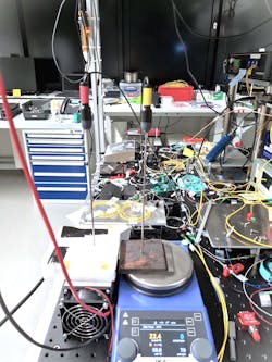 FIGURE 2. The group’s optoacoustic setup and heat plate to control the temperature in a liquid-core optical fiber. FIGURE 2. The group’s optoacoustic setup and heat plate to control the temperature in a liquid-core optical fiber.
