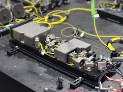 QU-SOURCE leverages a spontaneous four-wave mixing (SFWM) within an atomic vapor (rubidium) to produce highly pure polarization-entangled photon pairs. QU-SOURCE leverages a spontaneous four-wave mixing (SFWM) within an atomic vapor (rubidium) to produce highly pure polarization-entangled photon pairs.
