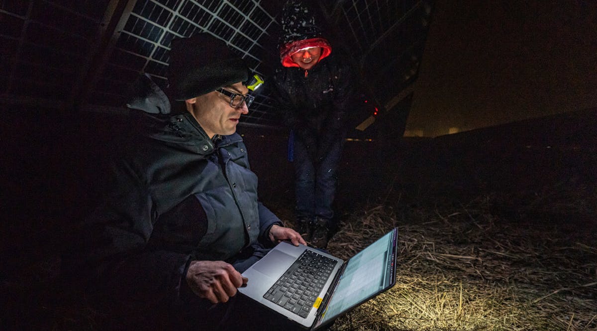 National Renewable Energy Laboratory (NREL) researchers Tim Silverman and Nicole Luna look over data generated by PLatypus, which was connected to a photovoltaics system on the Flatirons campus.