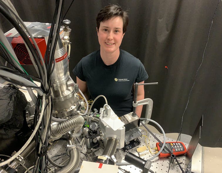 FIGURE 2. Sin&eacute;ad A. Ryan stands behind the sample chamber. The sample is magnetized by a projection field electromagnet and positioned via in-vacuum translation stages.