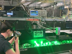 FIGURE 4. Working on the amplifier. Beams are located using an infrared viewer, and laser pulses are measured with an oscilloscope. FIGURE 4. Working on the amplifier. Beams are located using an infrared viewer, and laser pulses are measured with an oscilloscope.