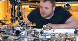 FIGURE 2. Óscar Helgason in the lab with the team’s microcomb. FIGURE 2. Óscar Helgason in the lab with the team’s microcomb.