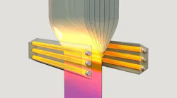 FIGURE 1. A monolithic polymer stack is drawn in one direction through a heating zone to form the filters.