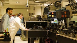 FIGURE 4. Hegelich (in white) and Eli Medina, a laser technician, looking at laser beam profiles within the Texas Petawatt Laser system. FIGURE 4. Hegelich (in white) and Eli Medina, a laser technician, looking at laser beam profiles within the Texas Petawatt Laser system.