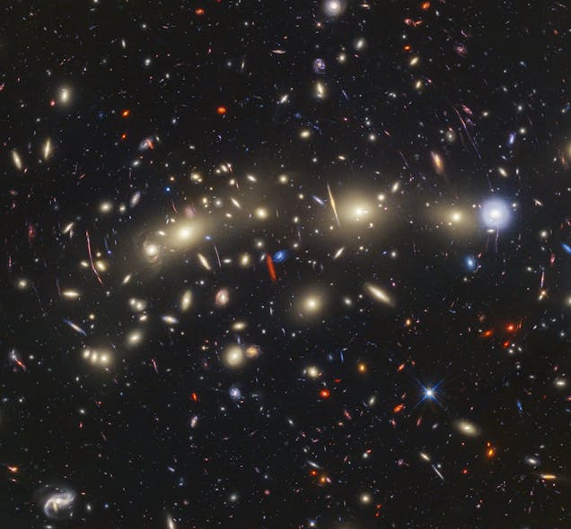 FIGURE 3. This panchromatic view of galaxy cluster MACS0416 was created by combining infrared observations from Webb with visible-light data from Hubble.