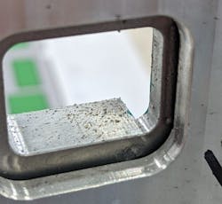 FIGURE 4. An image of a window and the resulting ejected materials; this view is from the laser side. FIGURE 4. An image of a window and the resulting ejected materials; this view is from the laser side.