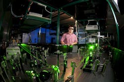 FIGURE 1. Hui Zhao in the University of Kansas Ultrafast Laser Lab with his team’s setup. FIGURE 1. Hui Zhao in the University of Kansas Ultrafast Laser Lab with his team’s setup.
