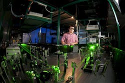 FIGURE 1. Hui Zhao in the University of Kansas Ultrafast Laser Lab with his team&rsquo;s setup.