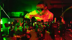 Bereneice Sephton in the quantum optics lab with the team’s quantum transport experiment in the foreground.