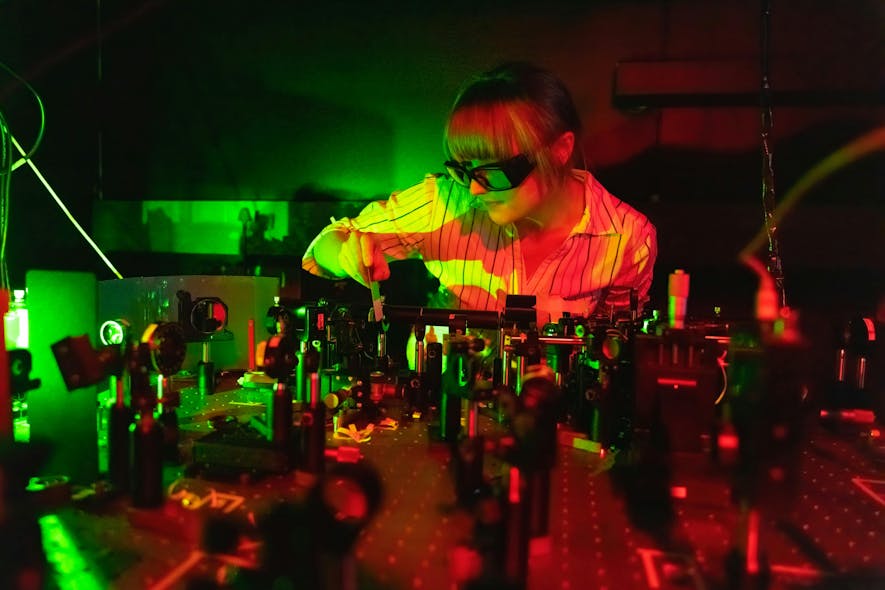 Bereneice Sephton in the quantum optics lab with the team&rsquo;s quantum transport experiment in the foreground.